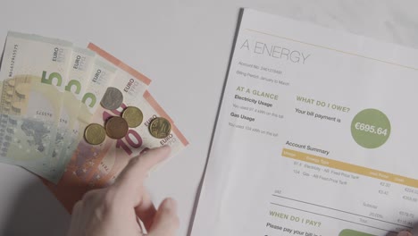 hand counting currency in euros to pay for european energy bill 1