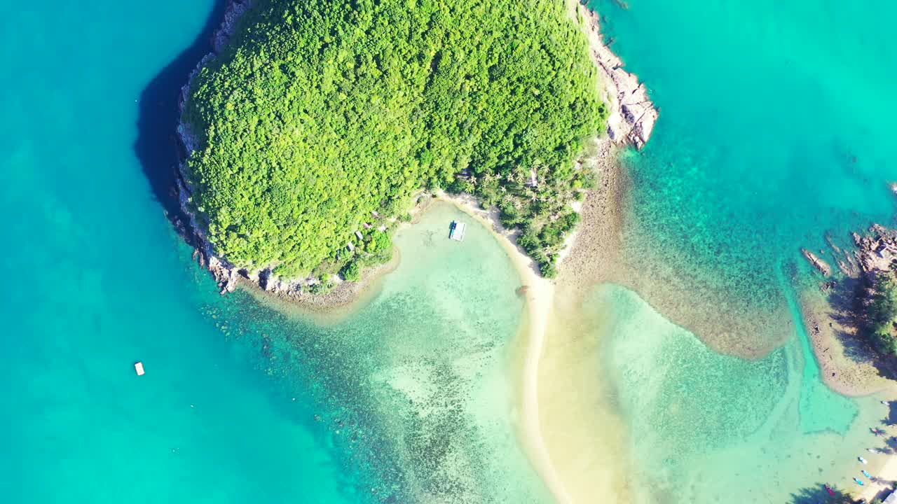 Paradise vacation gateway on tropical island with lush vegetation and rocky coastline surrounded by turquoise lagoon in Thailand