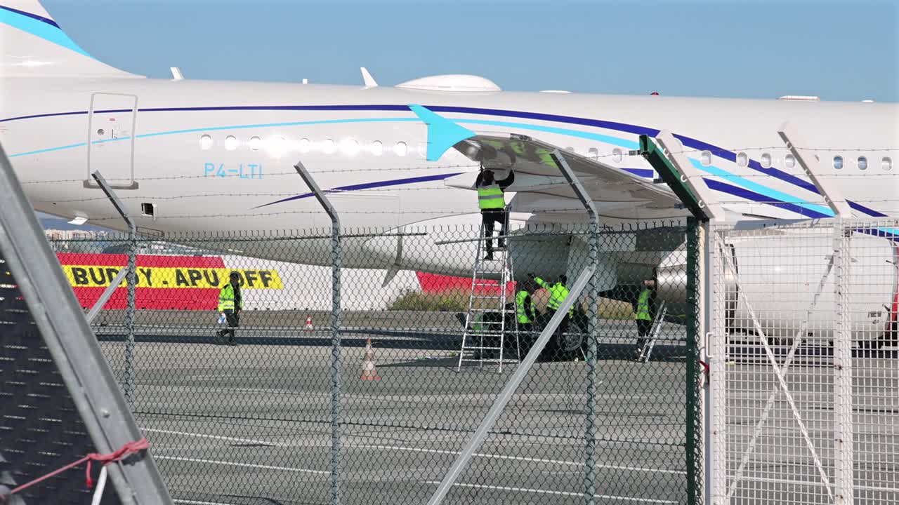 Airport crew getting business jet ready maintenance