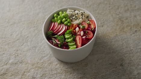 Composition-of-bowl-of-rice-and-vegetables-with-chopsticks-on-white-background