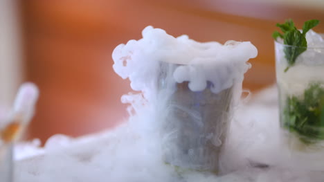 Dry-Ice-In-Glass-While-Bartender-Preparing-Drink-3