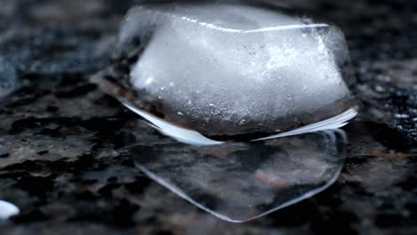 ice melting and sliding across a kitchen counter.