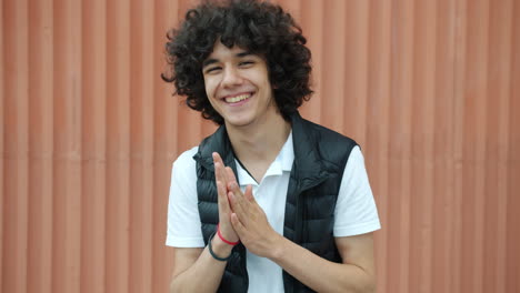 smiling teenager with folded hands