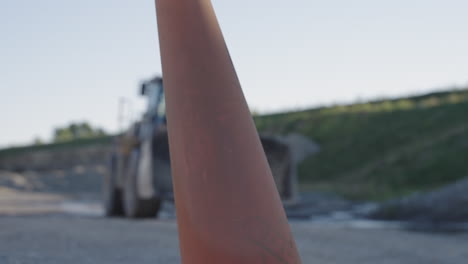 Out-of-Focus-Slow-Motion-Shot-of-Front-Loader-at-Construction-Site