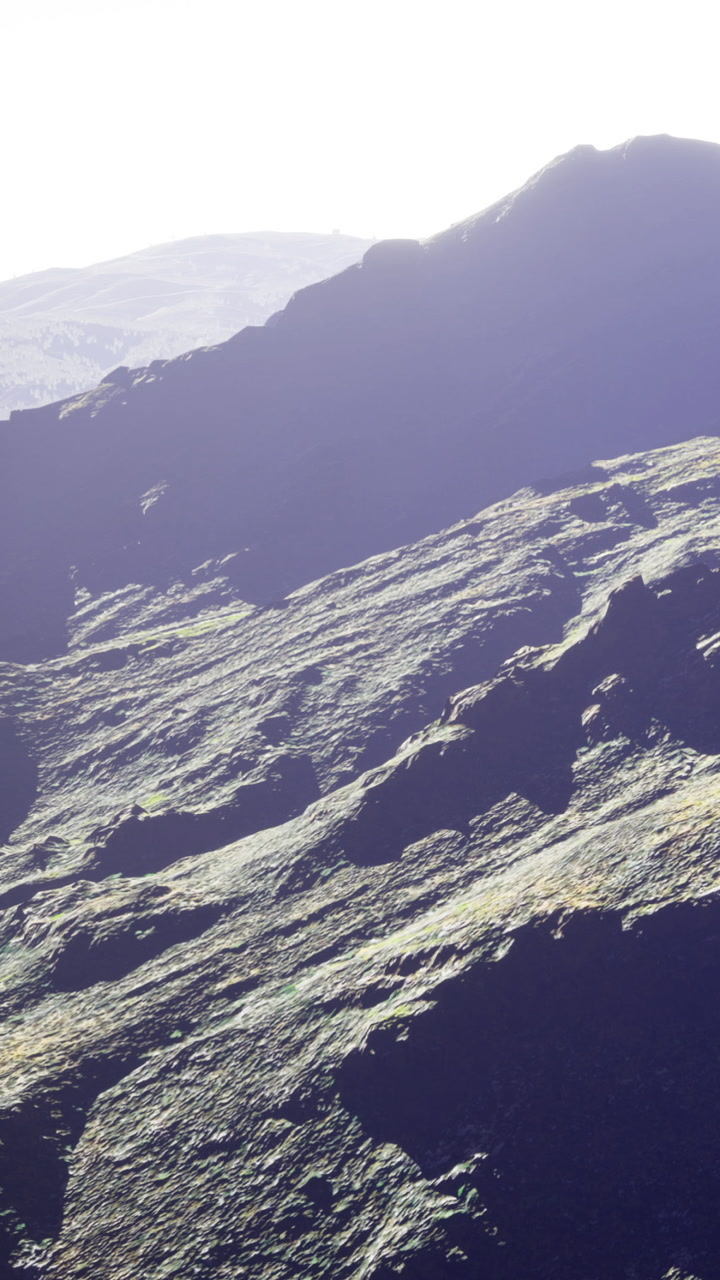 Majestic mountain landscape with gentle light illuminating rugged terrain