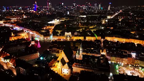 aerial, drone video of warsaw center in the night, with a old town and business district.