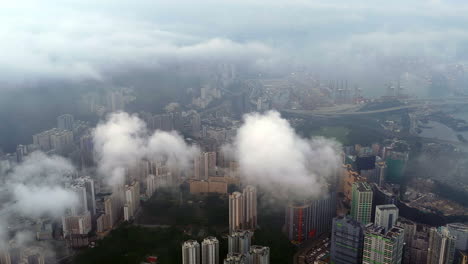 cinematic aerial view of the hong kong skyline in morning light with cloud cover, showcasing the metropolitan city as a symbol of global finance, modern architecture, travel, and business