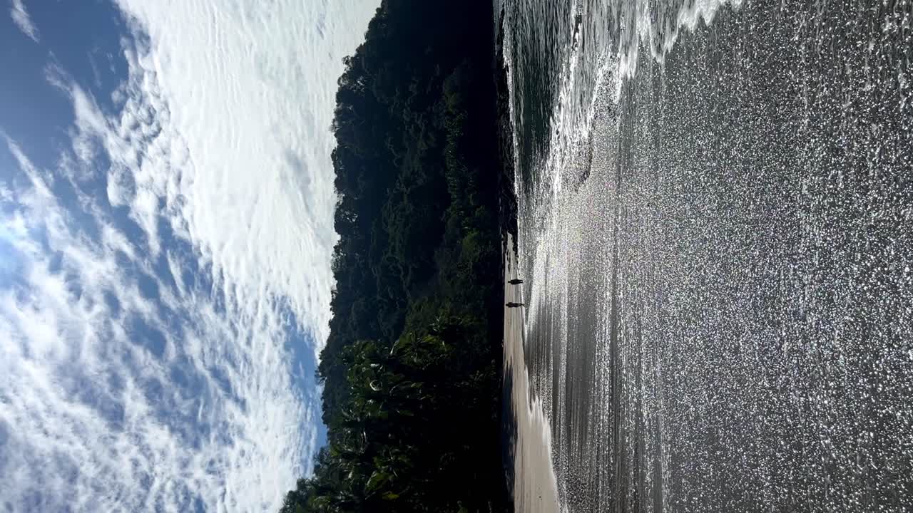 Walking along the quiet coast of Puntarenas beach, Costa Rica.