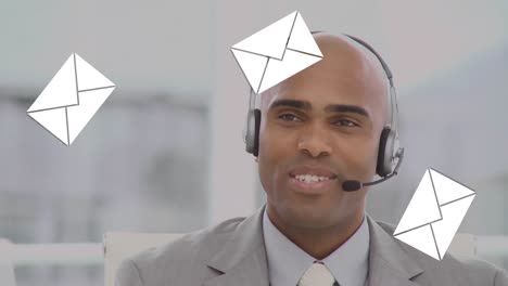 Animation-of-emails-icons-over-man-wearing-phone-headset