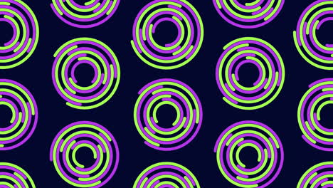 vibrant spiral pattern purple and green spirals on black background
