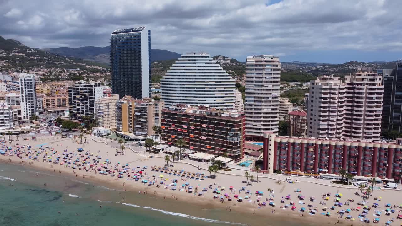Air view of the urban area of calpe by a crowded beach, Spain