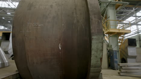 large metal cylinder in industrial setting