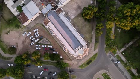 Aerial-top-down-descending-over-a-neogothic-church-at-golden-hour