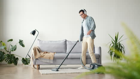 man vacuuming in a modern living room