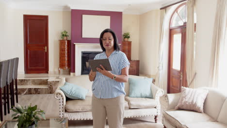 senior diverse couple discussing home renovation plans using tablet in living room