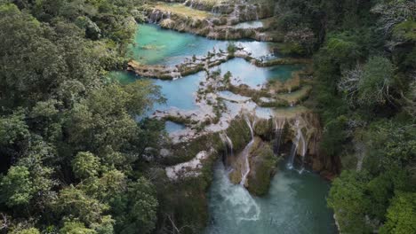 Water-flows-by-underground-cave-and-surface-waterfalls,-Semuc-Champey