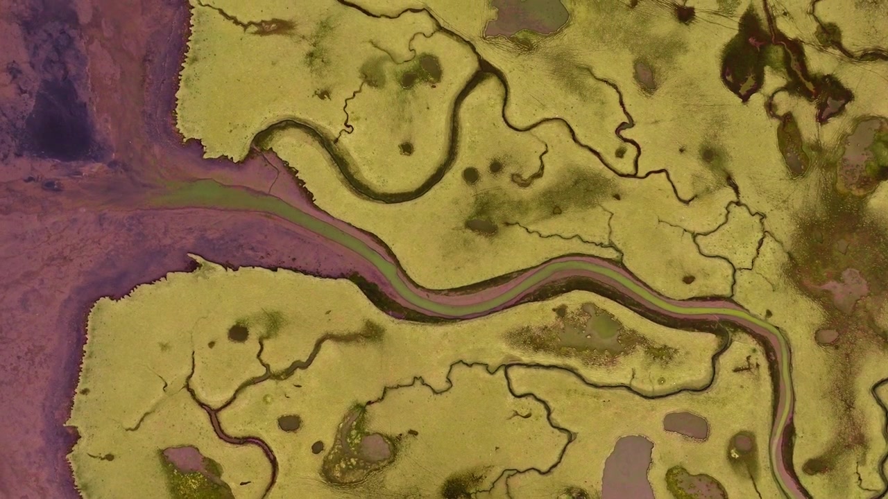 Wide aerial of colorful braided tidal river landscape on Iceland