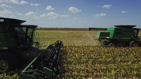 aerial - combine harvester cultivates land, agriculture field, mexico, truck right shot