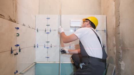 caucasian man builder engineer in hard hat holding hammer check tool beat helmet safety on