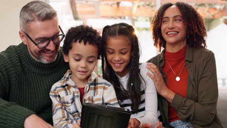 a family is gathered together looking at a tablet