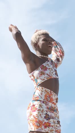 happy black non-binary person dancing on street and enjoying freedom
