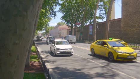 traffic on a city street with cars and motorcycles