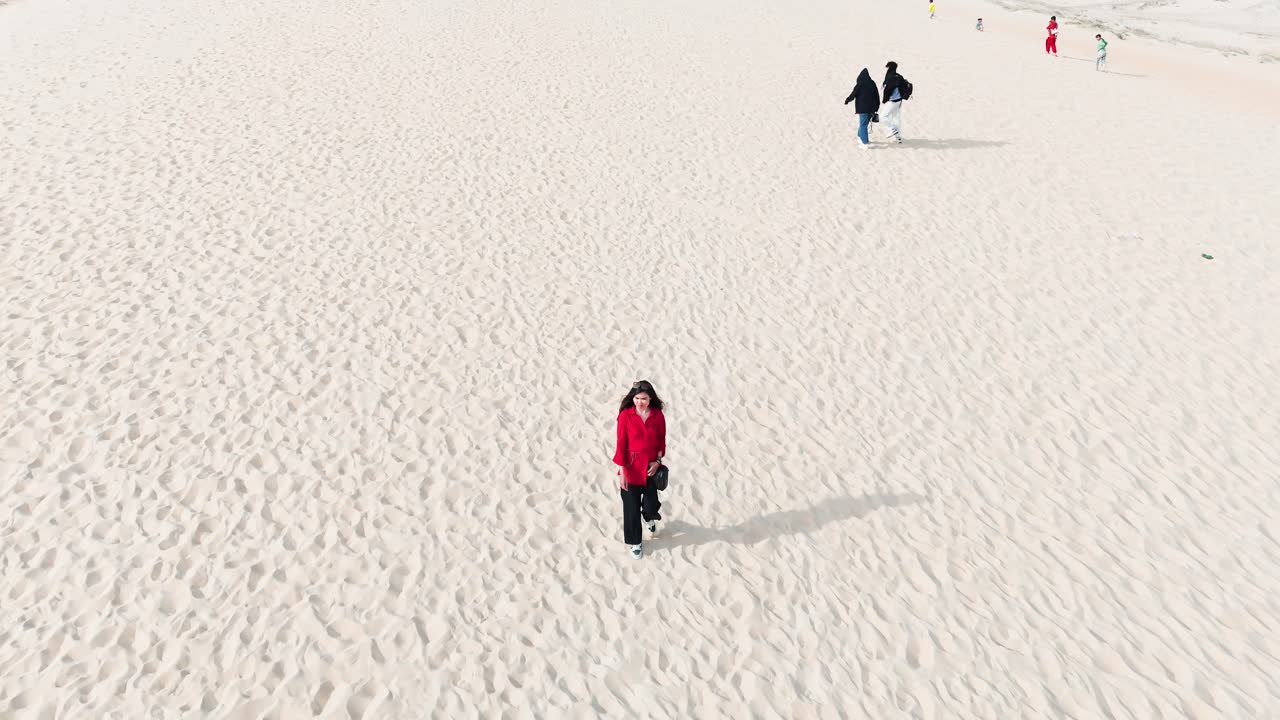 Aerial View Orbit of a Girl Walking in the Desert in Vietnam.