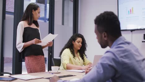 Diverse-group-of-business-people-working-together,-discussing-work-in-modern-office