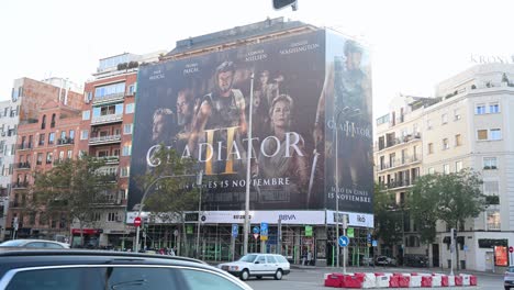vehicles drive past a large billboard promoting gladiator ii (gladiator 2), produced by red wagon entertainment, distributed by paramount pictures, and directed by ridley scott, in madrid.