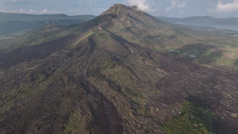aerial reveal of mt batur volcano crater and bali volcanic landscape, indonesia.
