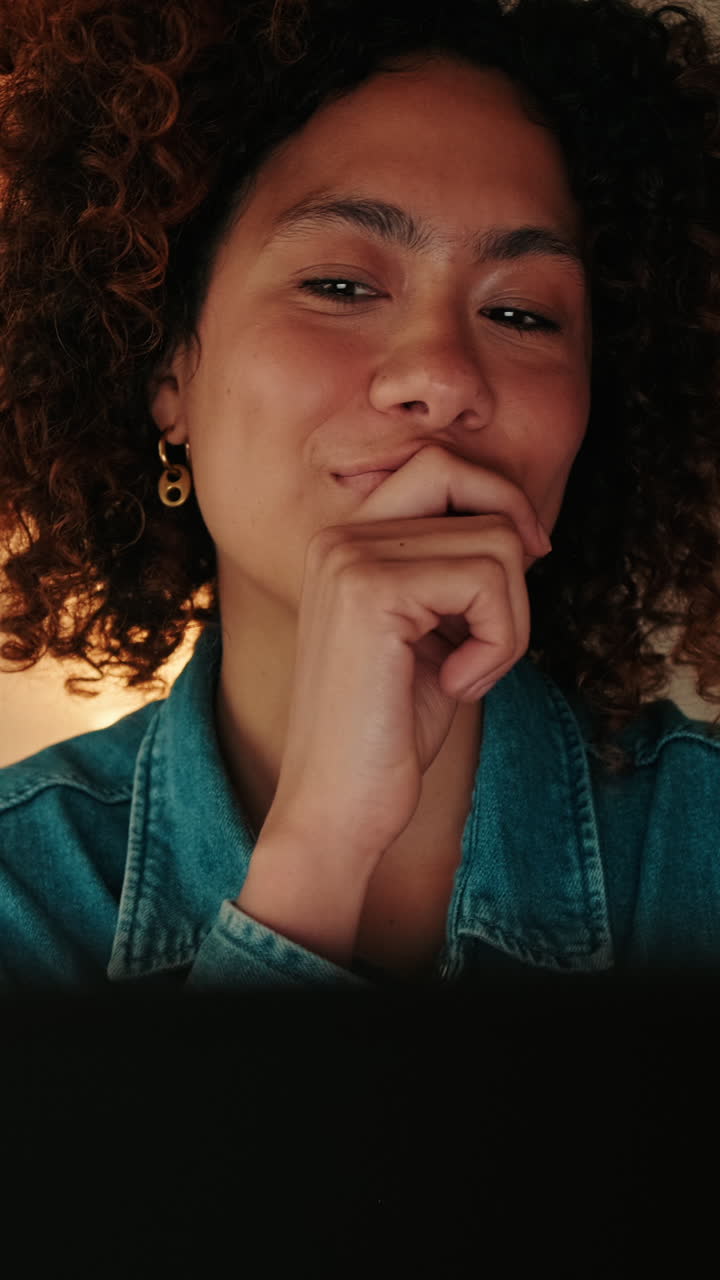Close-up of Young Woman Winking and Smiling While Looking at Screen