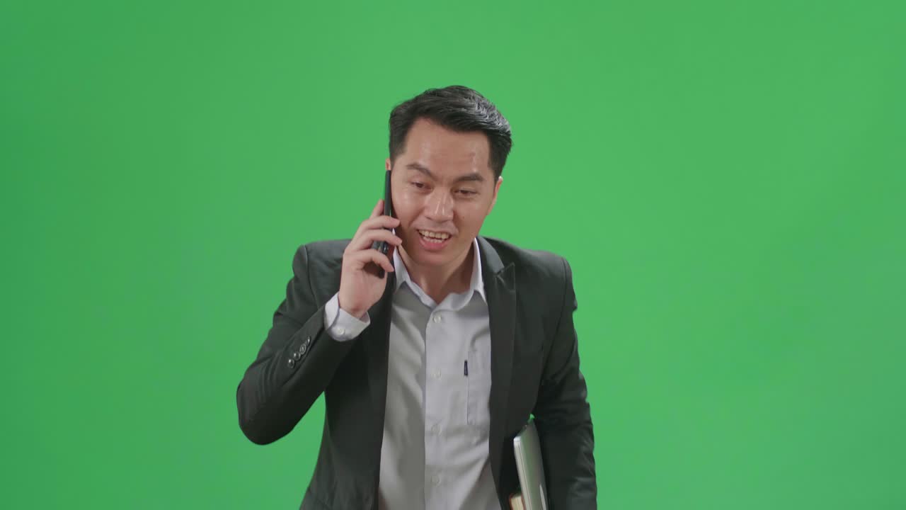 Asian Business Man Talking On Mobile Phone While Walk And Run On Green Screen Chroma Key