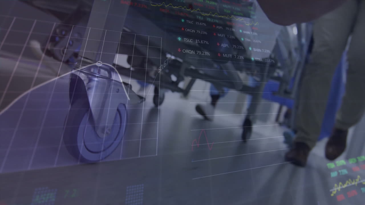 Stock market data animation over hospital staff moving medical equipment
