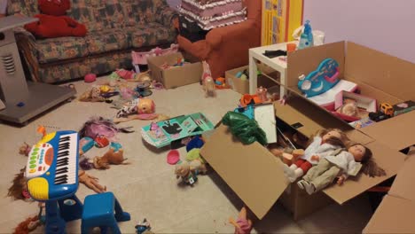 room for children's games with many toys thrown on the floor creating clutter boxes with dolls, sofa and piano toy, shooting traveling backwards, orders, galicia, spain