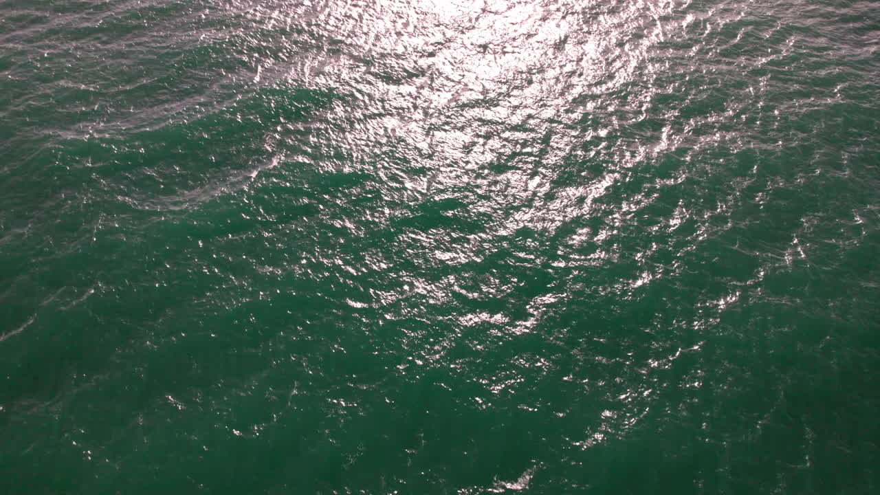 Aerial shot of the surgface of the sea near Alvor beach