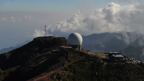 마데라 (madeira) 의 피코 아리에이로 (pico arieiro) 는 레이더 스테이션에서 짧은 거리에서 산과 구름을 배경으로 한 원형의 항공 사진입니다.
