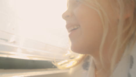 Little-girl-enjoying-sunlight-in-camper