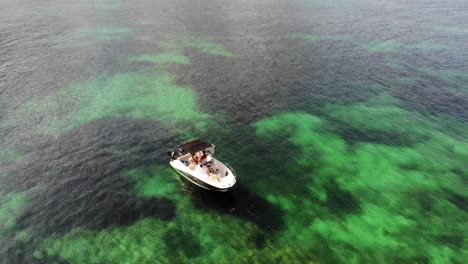 Tourists-enjoy-motorboat-in-crystal-green-water-of-Mallorca,-Spain