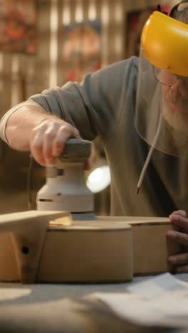 guitar body sanding process in a workshop