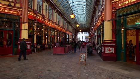 leadenhall market in london with tourists strolling and security present in a vibrant covered walkway