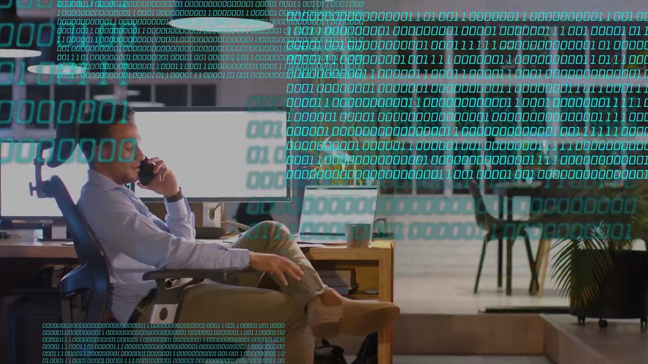 Male worker talking on phone in tech, binary streaming across desk, checking data, shifting posture