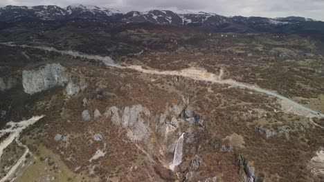 Drone-view-of-a-waterfall-between-rocks