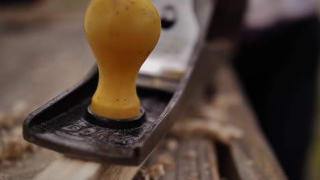 Close-up-of-a-plane-shaving-wood