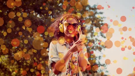 happy mixed-race woman dancing while she is listening music thanks to his headphones