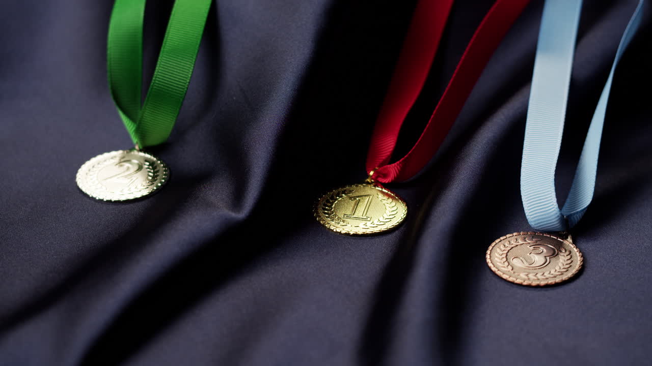 First, Second, and Third Place Medals on Dark Draped Fabric