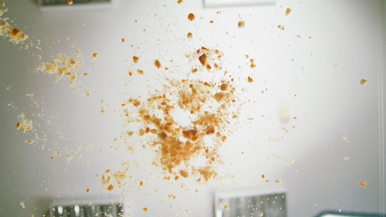 Hand Sweeping Breadcrumbs from Glass Surface with a Brush