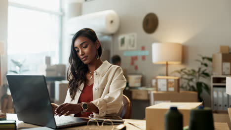 Phone,-laptop-and-a-woman-designer-in-her-workshop