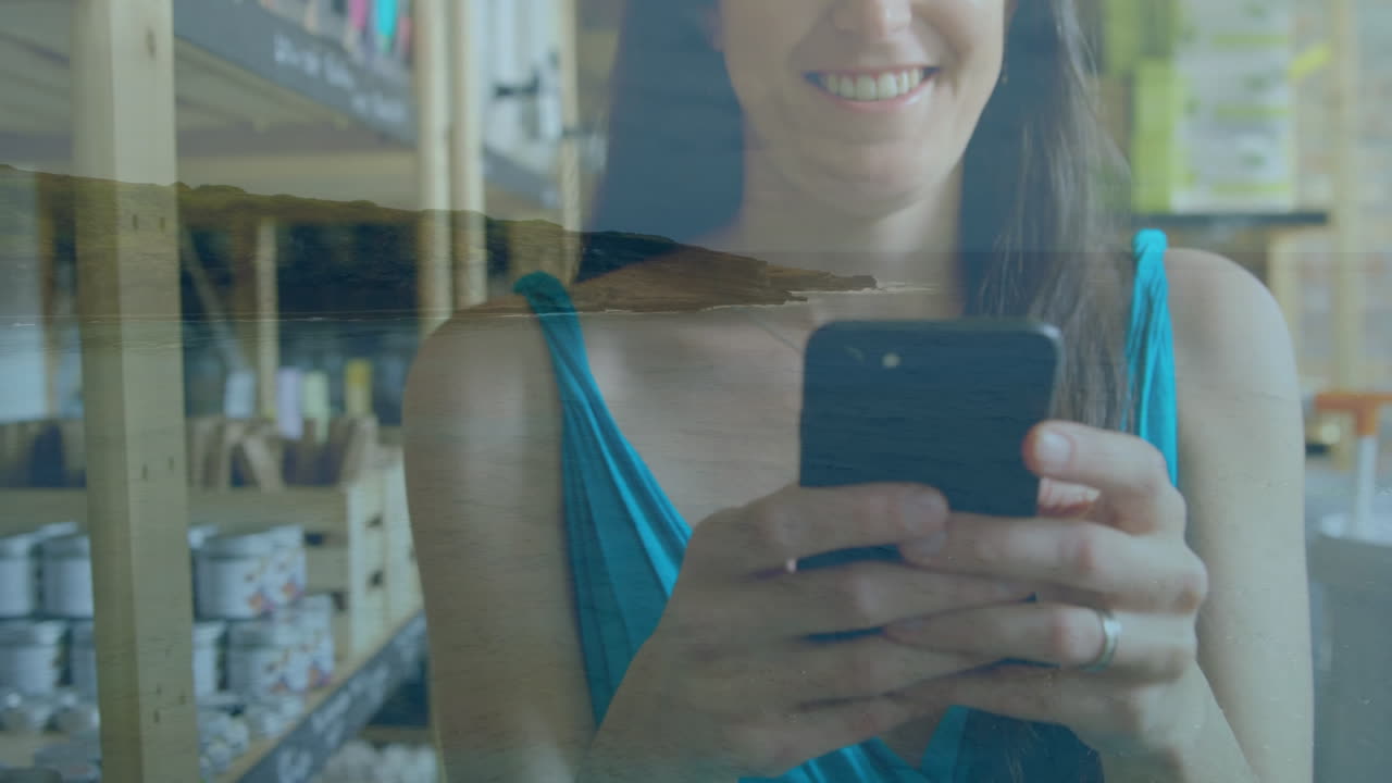animación de una mujer caucásica usando un teléfono inteligente sobre un paisaje marino