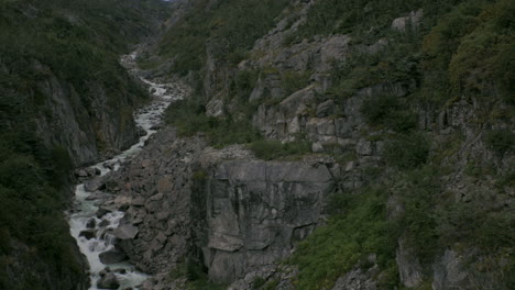 a small river flows within a rocky ravine