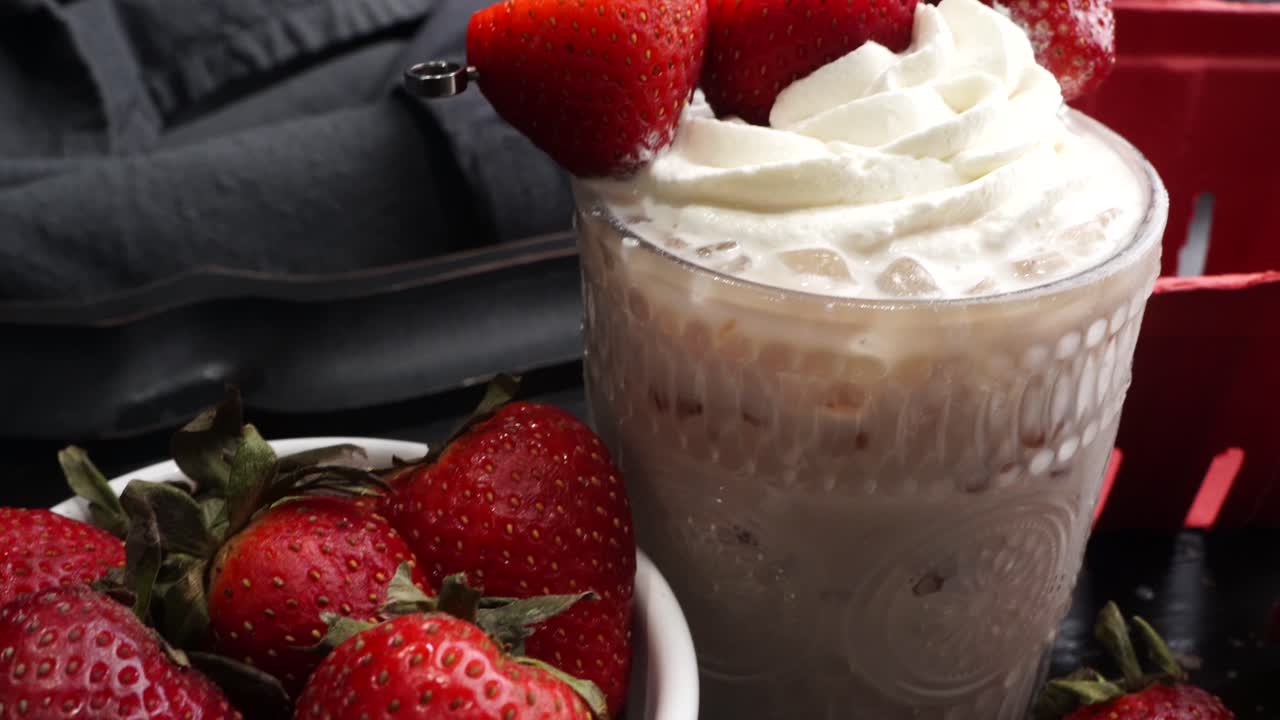 Pink cocktail drink with strawberry liqueur, vanilla vodka and cream. Party drink with strawberries. Fruit cocktail with fresh strawberries as a garnish. Cold and refreshing